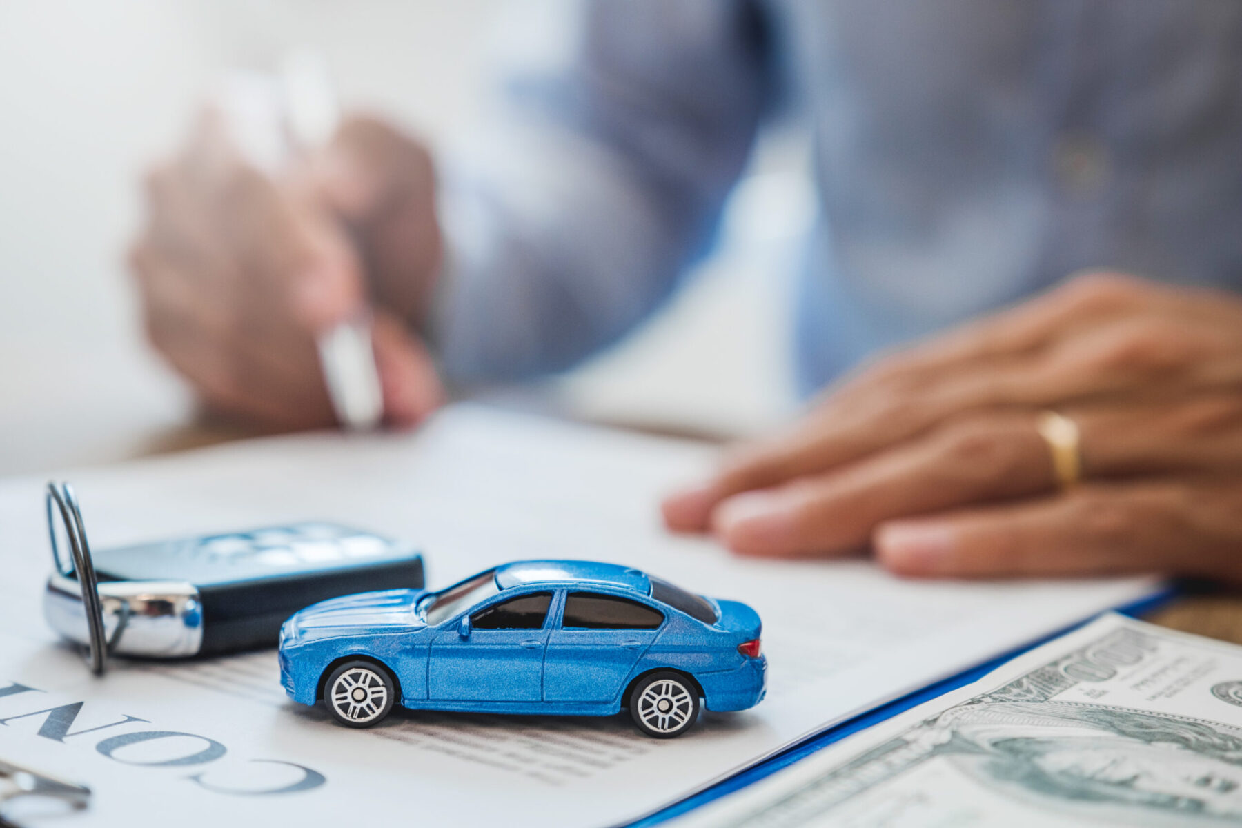 Sale agent deal to agreement successful car loan contract with customer and sign agreement contract Insurance car concept.